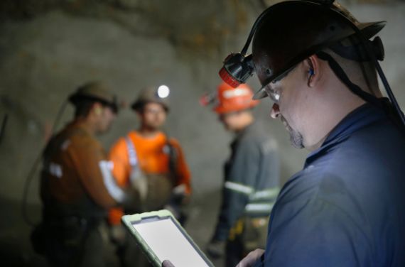 A photo of a man using a tablet.