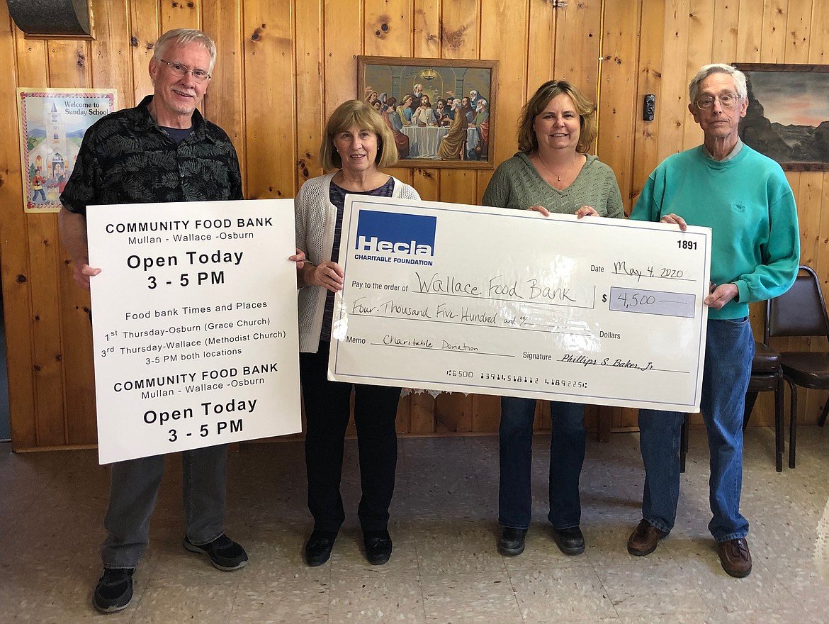 Group photo of people holding a giant check made out to Wallace Food Bank