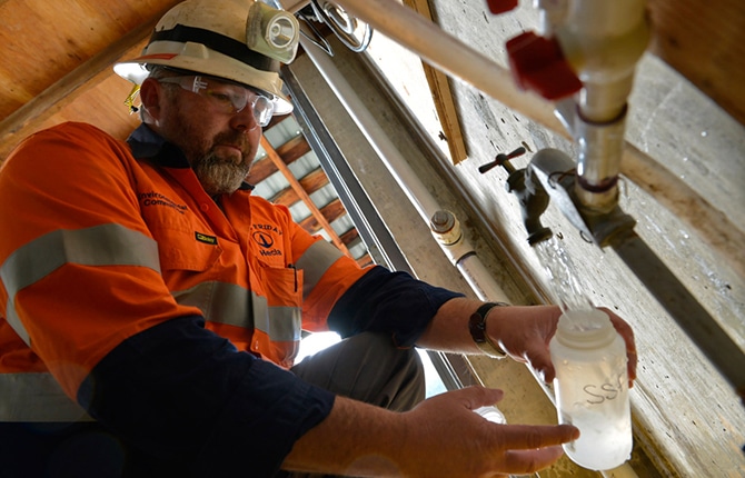 mining worker filling up a bottle of water